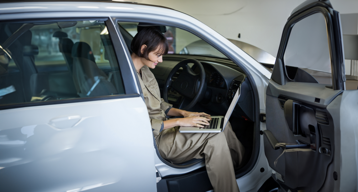 smiling-female-mechanic-using-laptop-1