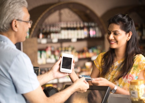 A merchant processes a payment in real-time using the customer’s mobile device in this image representative of India’s UPI system