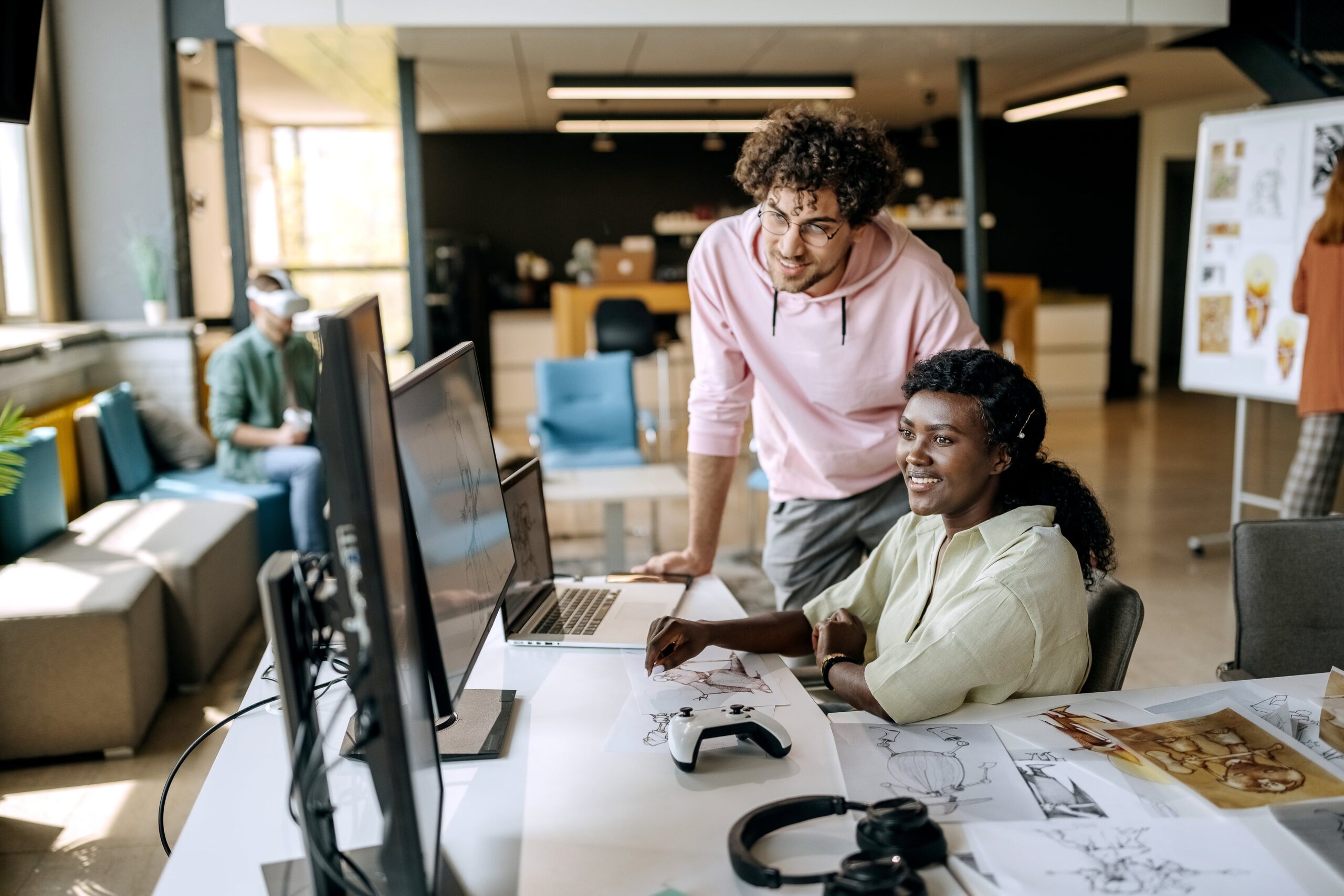 Two game developers collaborating on a game demo, showcasing real-time AI-powered content creation and cloud-native development for living games.