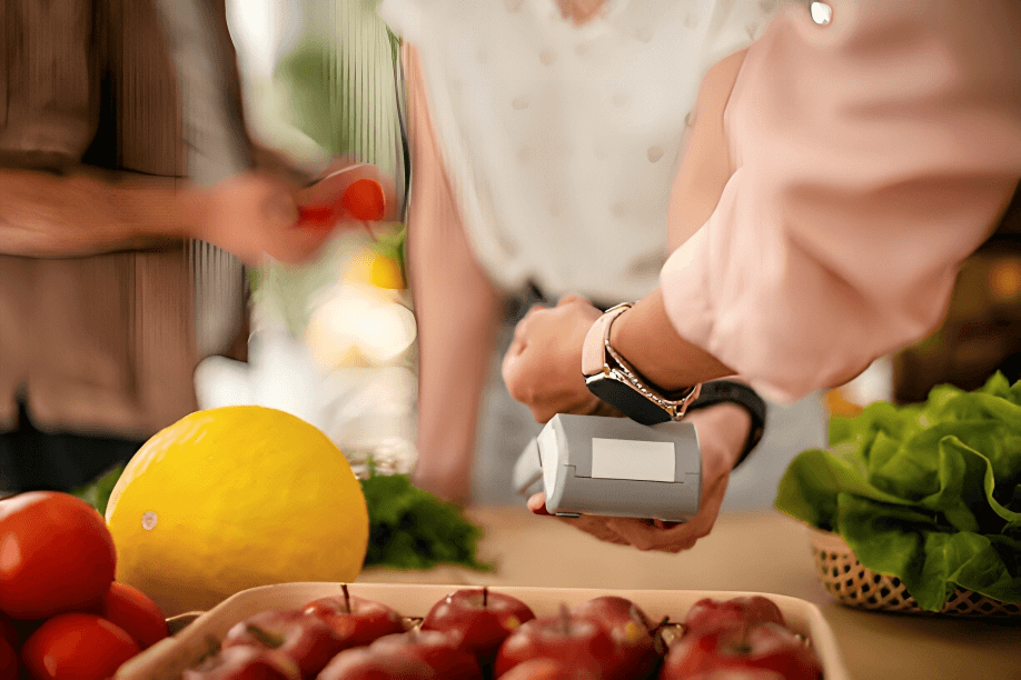 Person making a payment with a smartwatch, representing the evolution of financial services and the rise of decentralized, AI-powered business models.