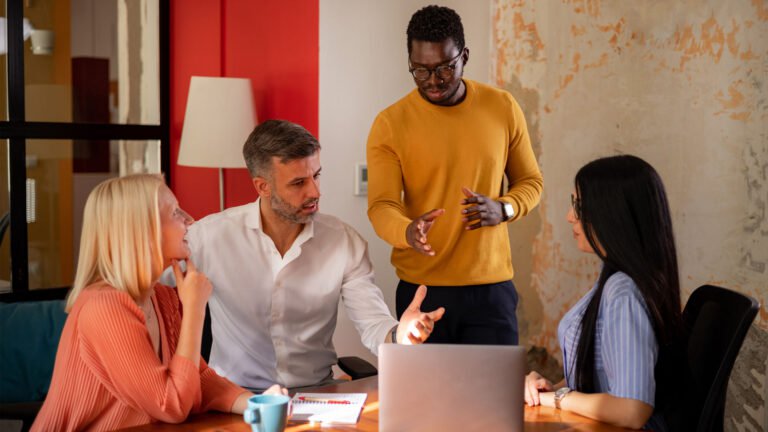 Diverse team of financial services professionals collaborating in a modern office, symbolizing digital transformation, regulatory agility, and platform-led innovation in banking and insurance.