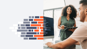 Two professionals reviewing ERP system dashboards in a modern office, representing AI-enabled enterprise software development and collaboration.